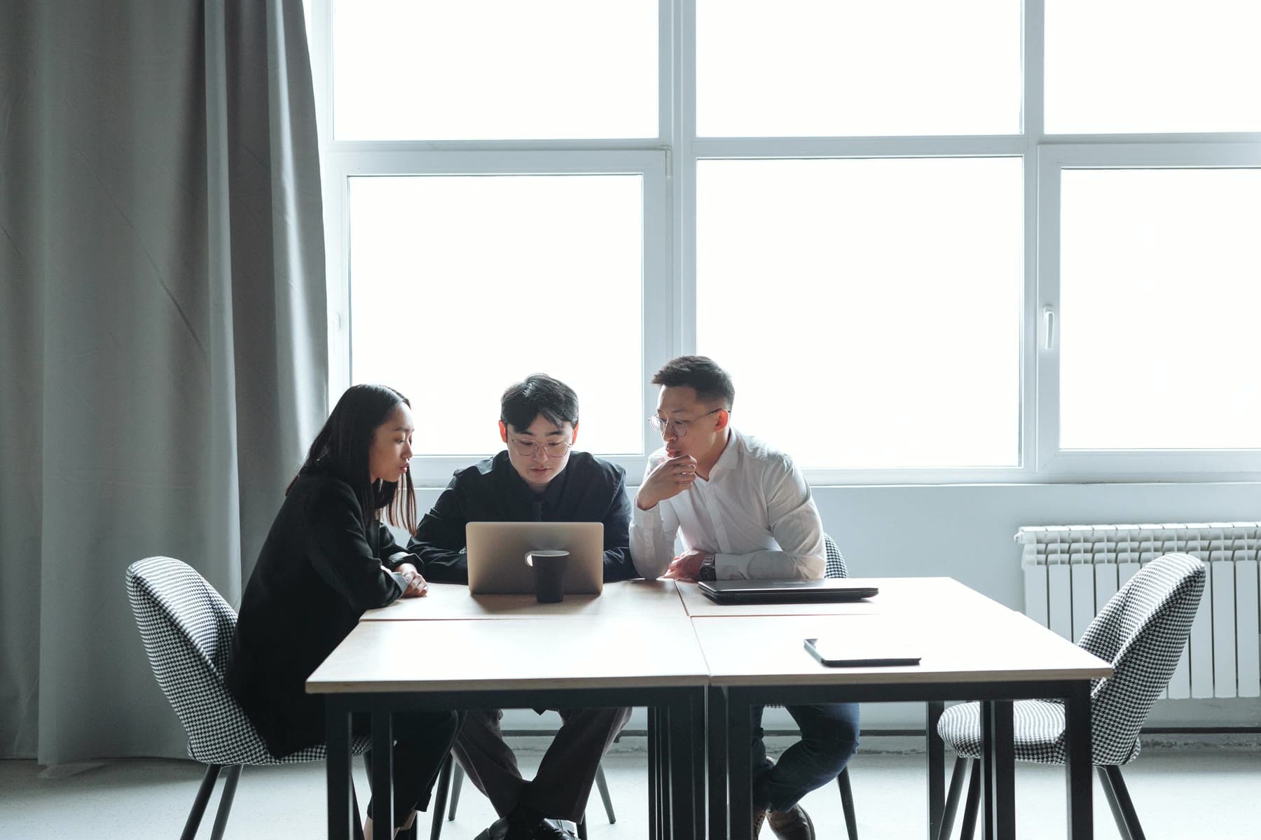Small team reviewing a plan together on a laptop
