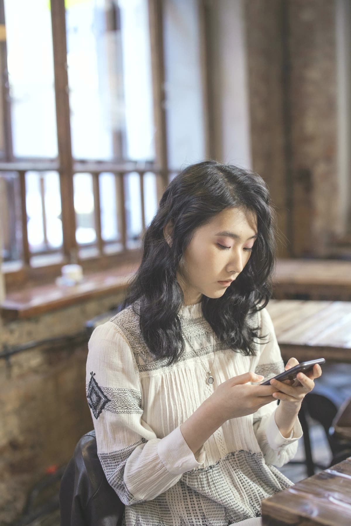 Woman replying to customer messages on her phone